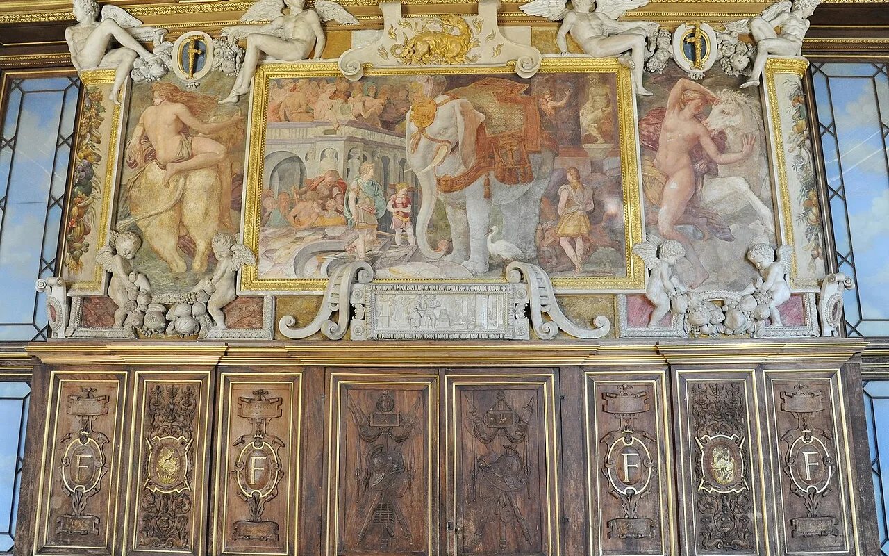 Carved stucco figures framing a painted panel